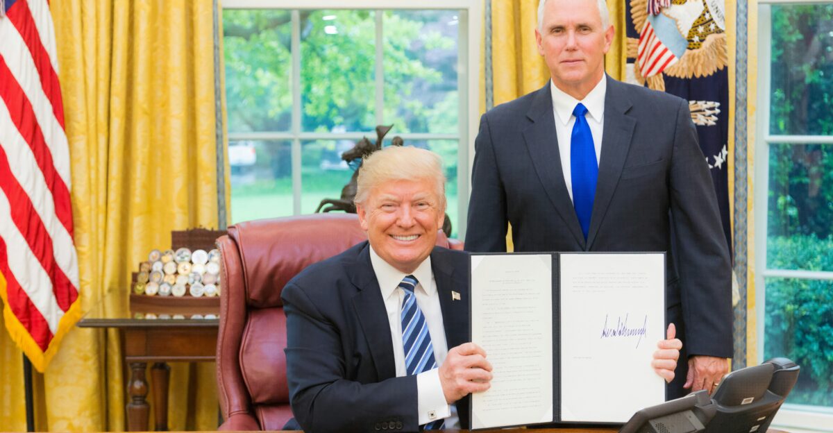 men in black suit sitting on red chair