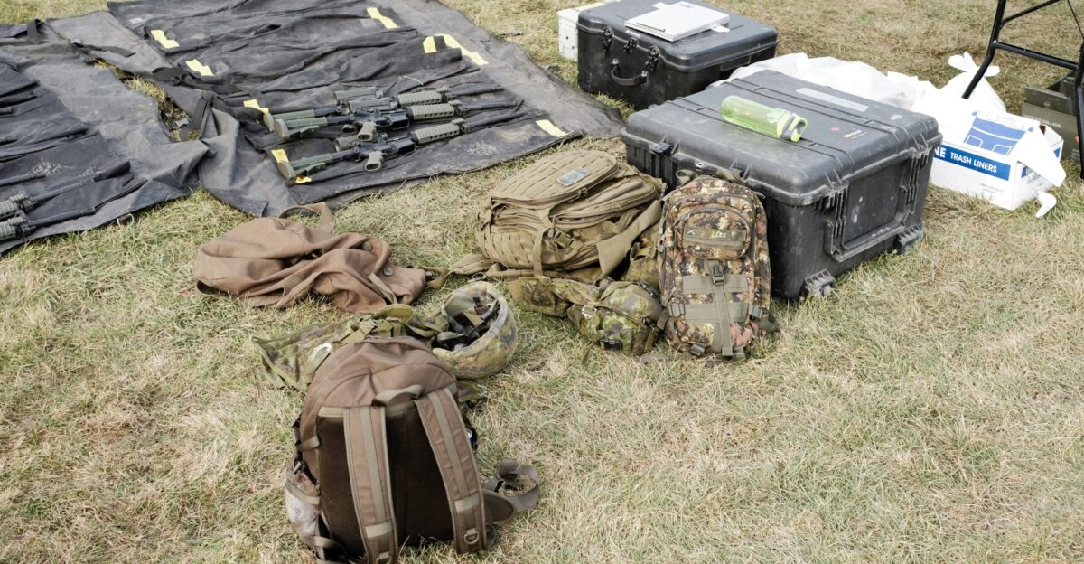 black and gray backpack on green grass field