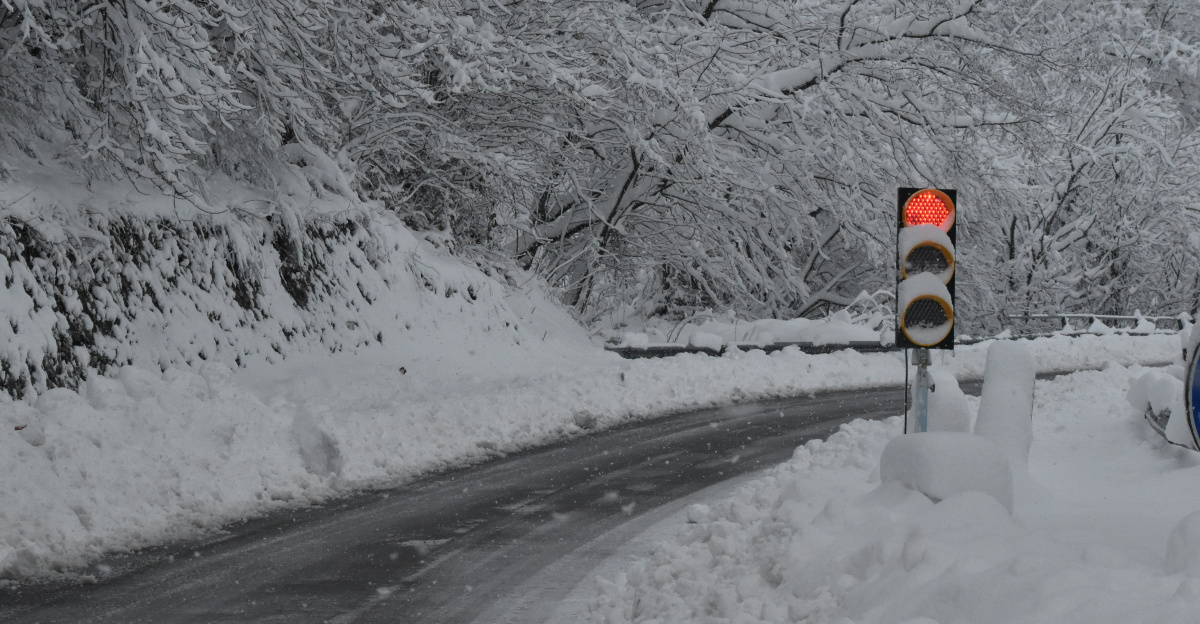 black car on road covered with snow