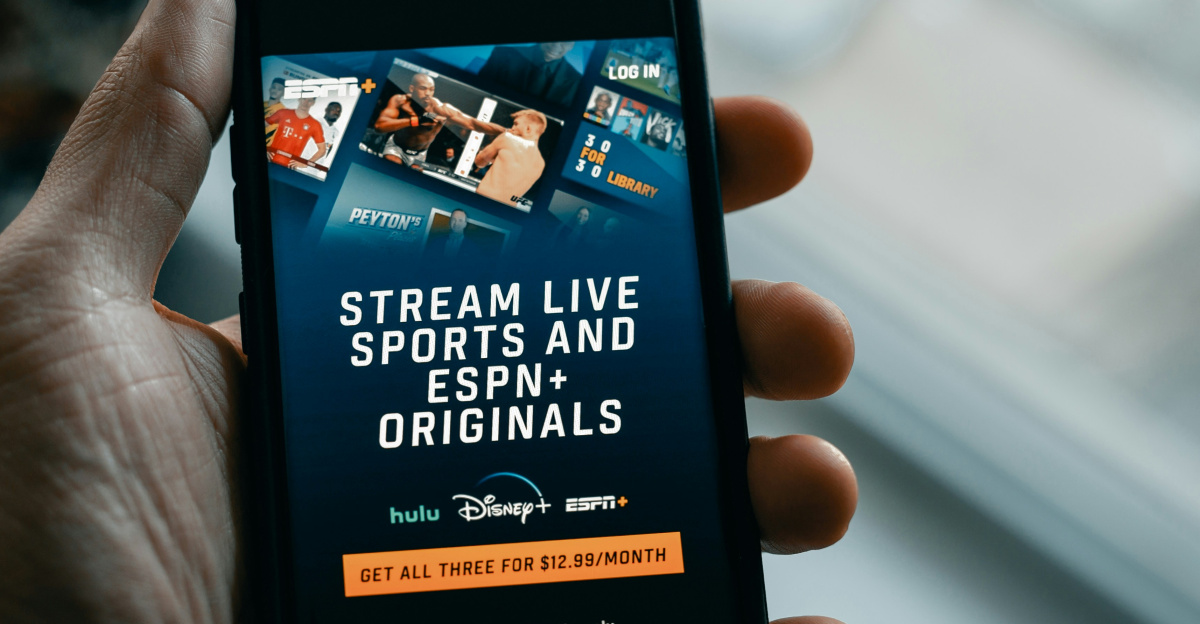 a person holding a cell phone in their hand