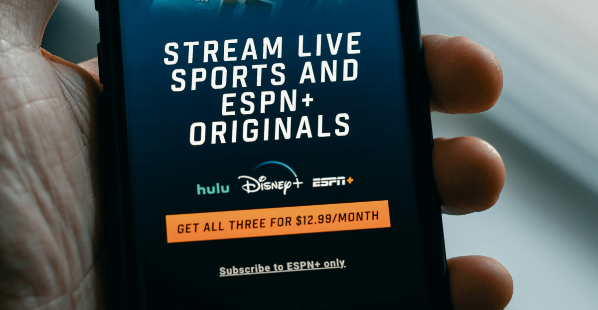 a person holding a cell phone in their hand