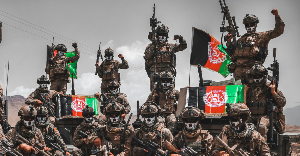 a group of military men riding on the back of a truck