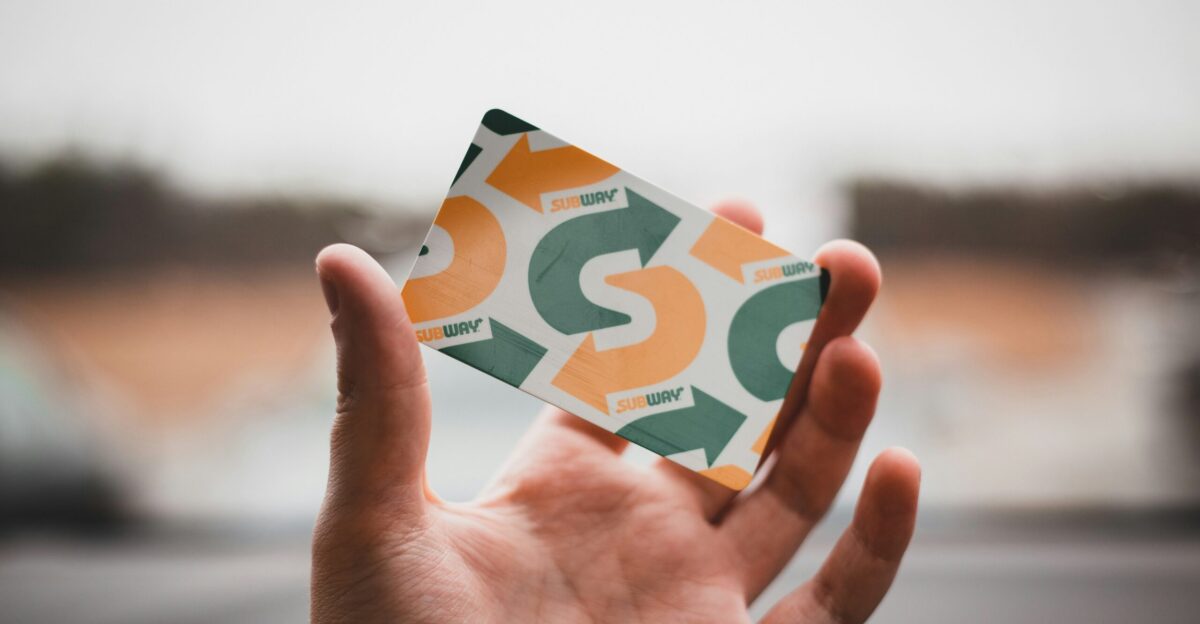 person holding green and white card