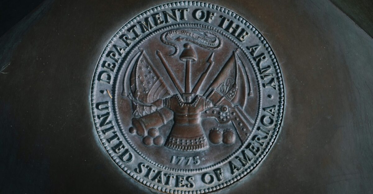 silver round coin on black textile