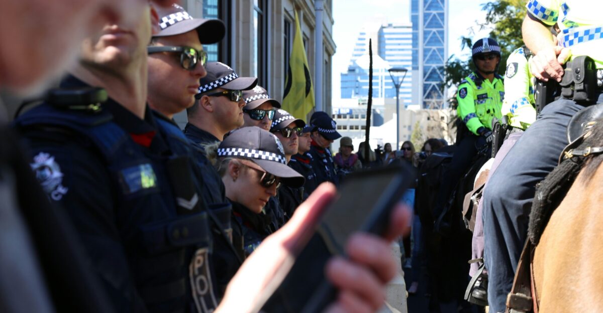man in black police uniform holding black smartphone