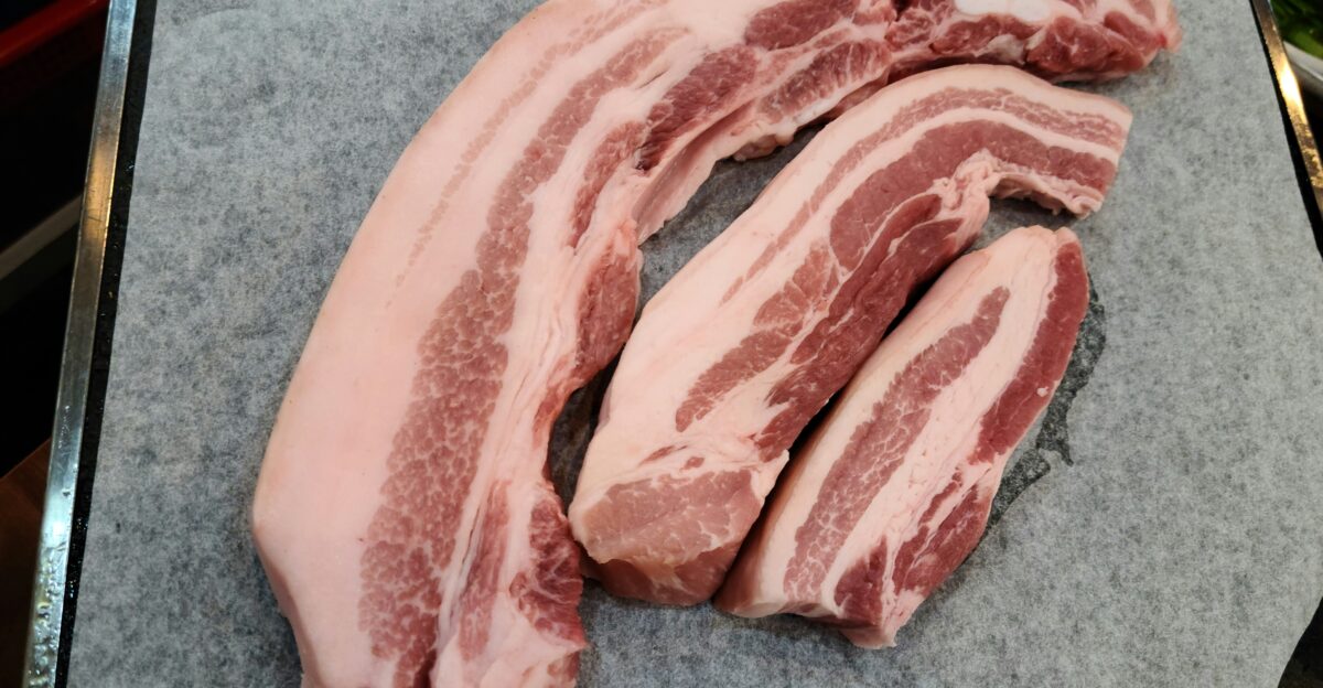 a pile of raw meat sitting on top of a cutting board