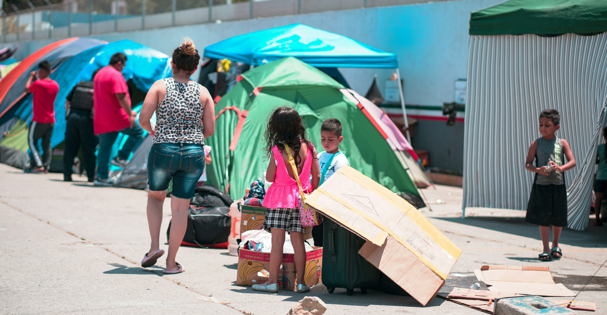 woman in blue and white polka dot dress holding yellow umbrella walking on street during daytime