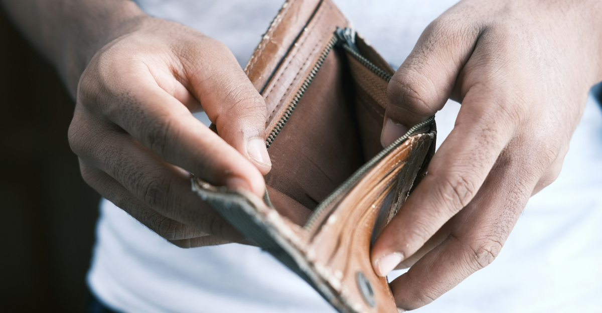 person holding brown leather bifold wallet