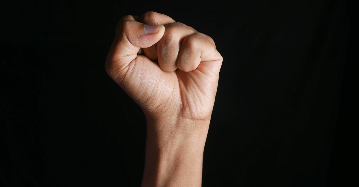 persons right hand doing fist gesture