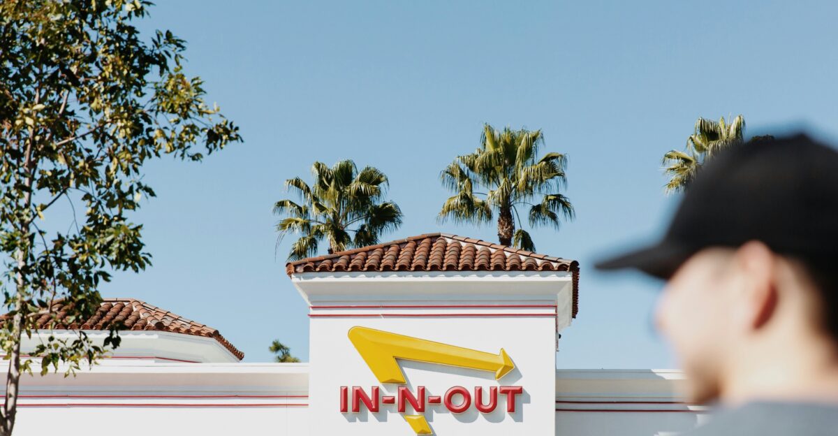 a man standing in front of a fast food restaurant