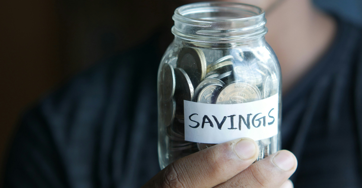 a man holding a jar with a savings label on it