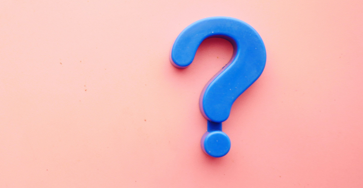 a blue question mark on a pink background