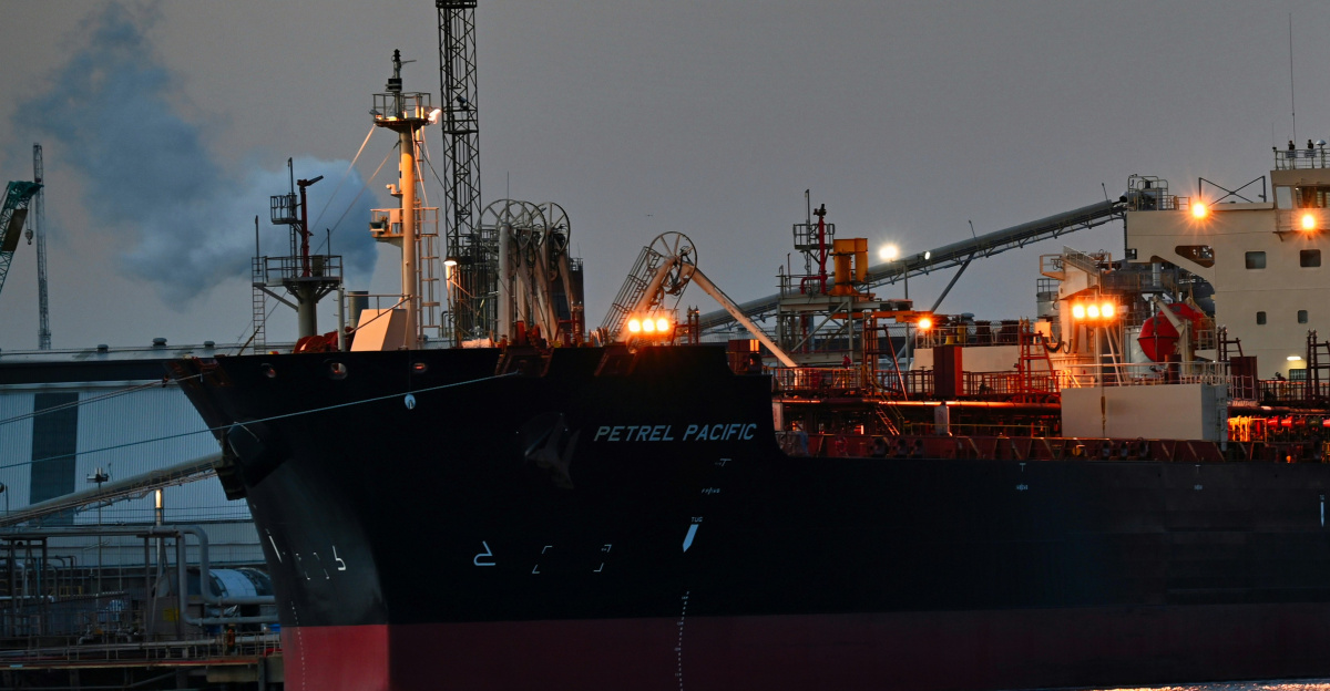 a large cargo ship in a harbor at night