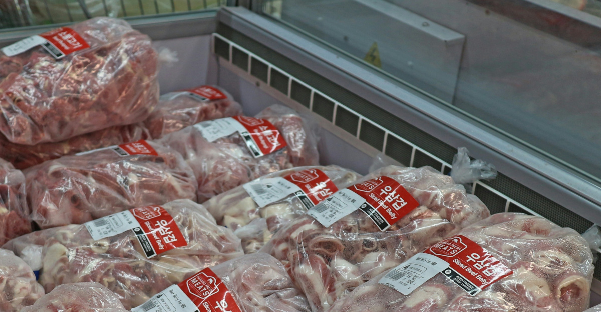 a pile of meat wrapped in plastic in a grocery store