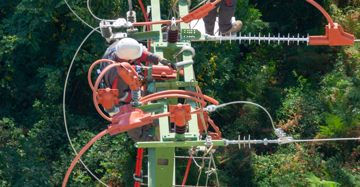 a man in a white shirt is on a high wire