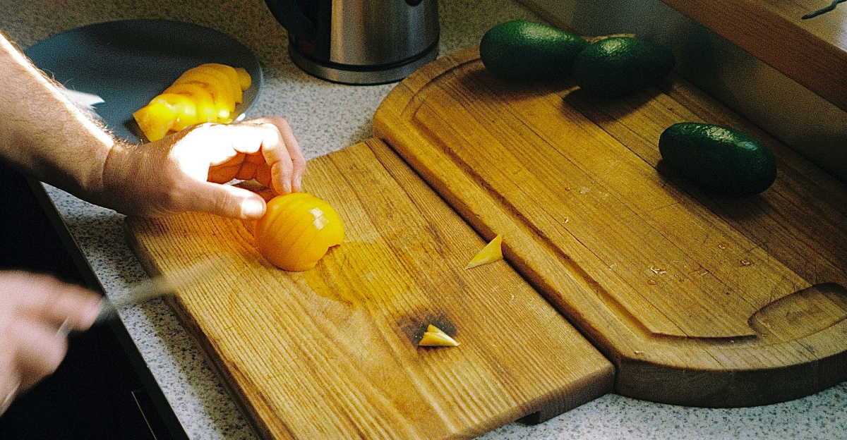 a person cutting up some food on a cutting board
