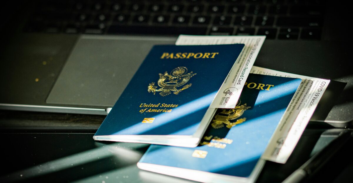 a passport sitting on top of a computer keyboard
