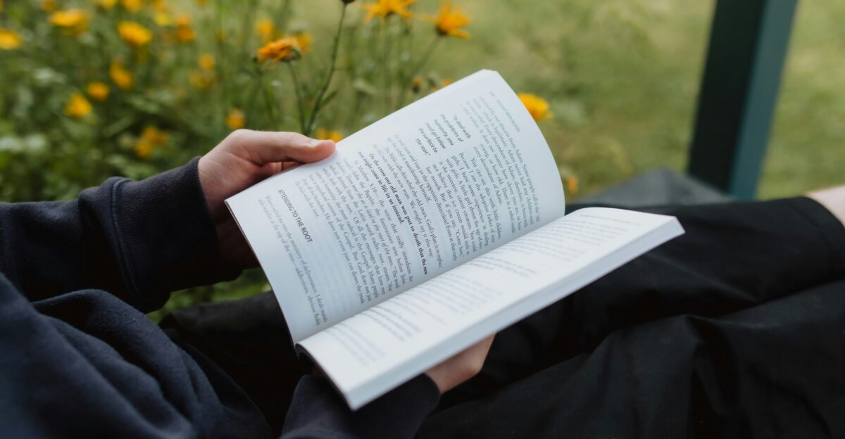 a person holding a book in their hands