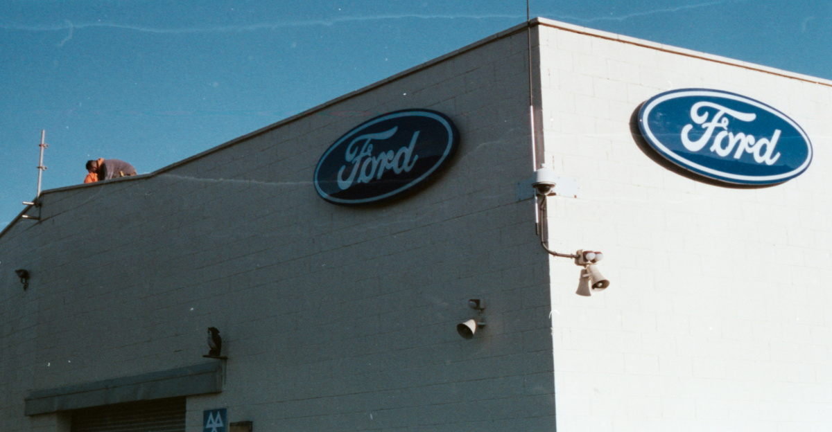 a ford dealership with a blue sky in the background