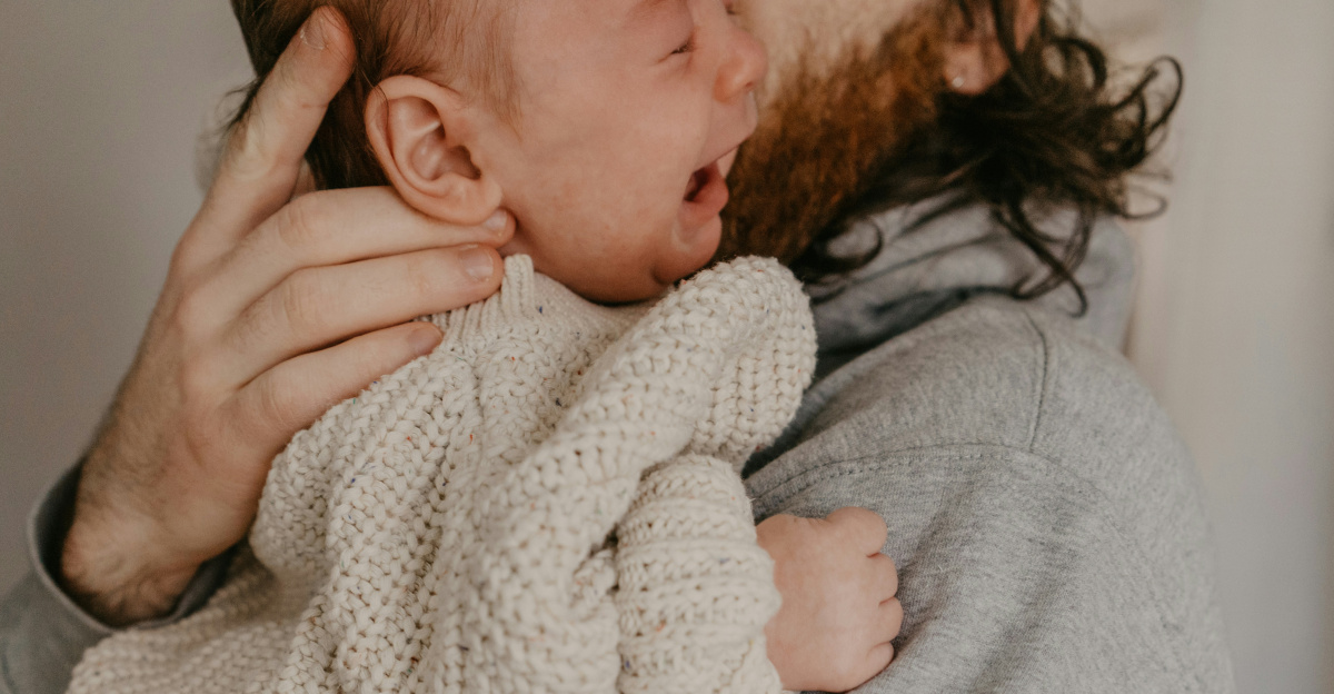 a man holding a baby in his arms