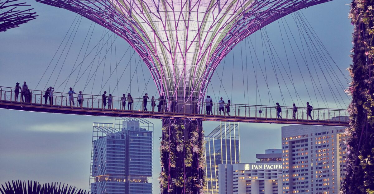 a group of people walking across a bridge