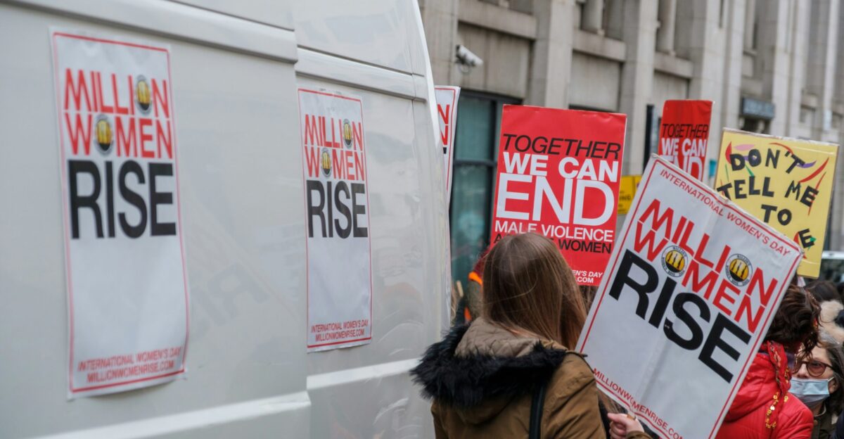 a group of people holding protest signs on a city street