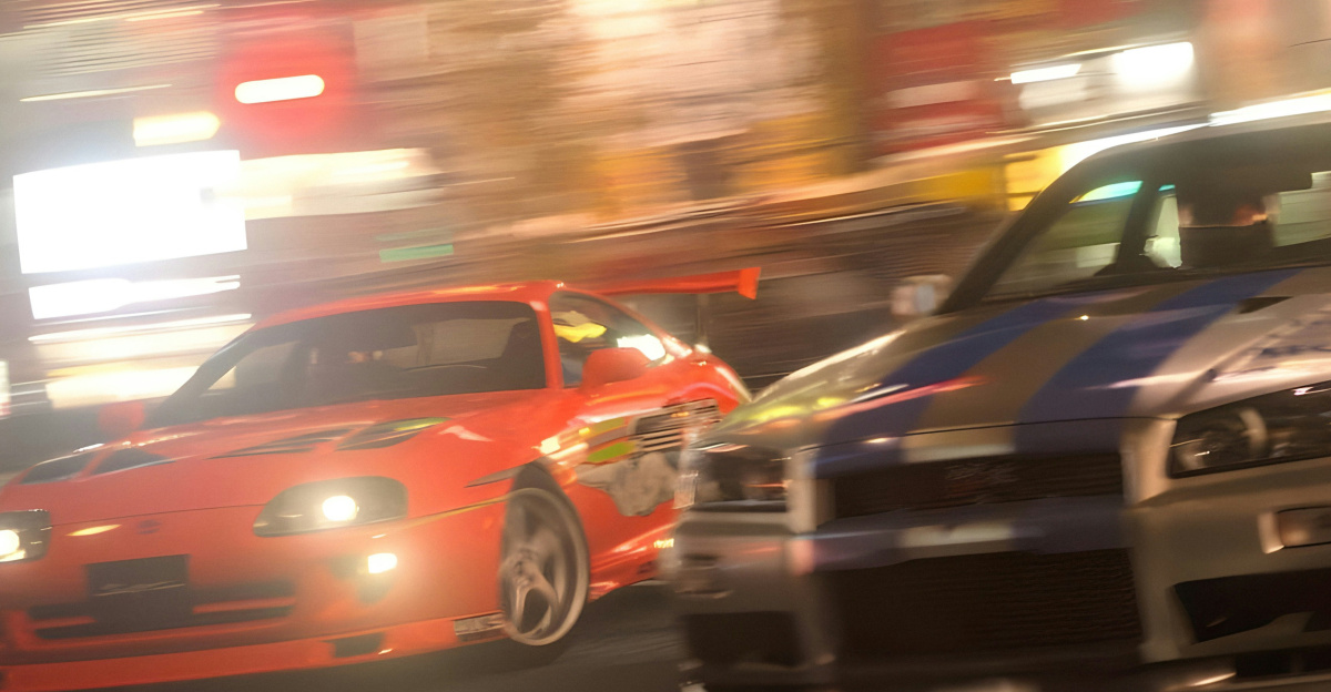 two cars driving down a city street at night