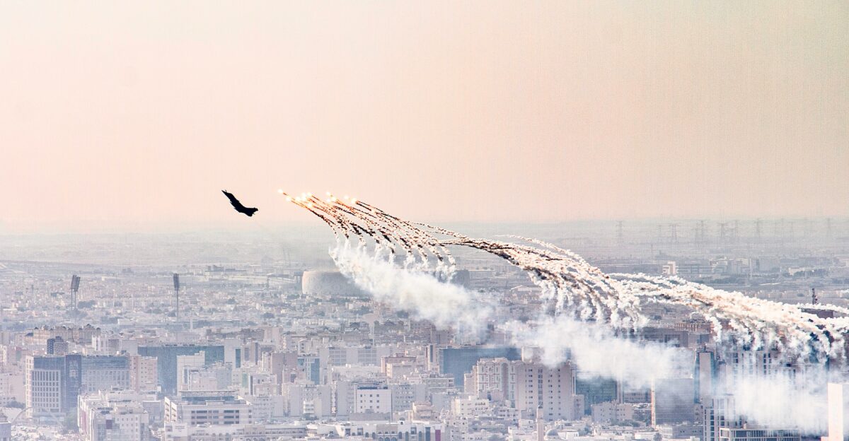 a group of airplanes flying over a city