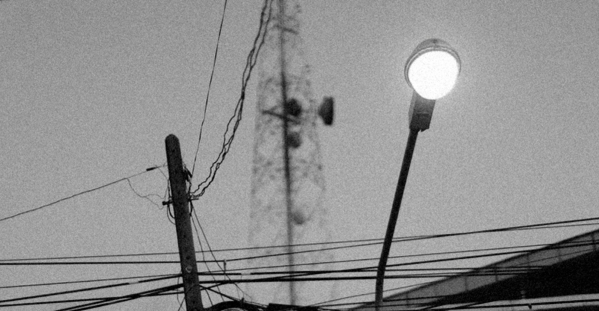 a black and white photo of a street light and wires