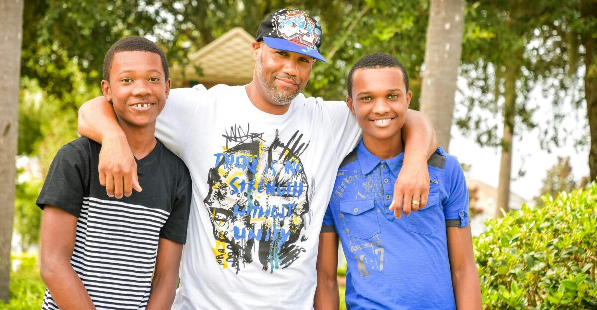 three young men standing next to each other