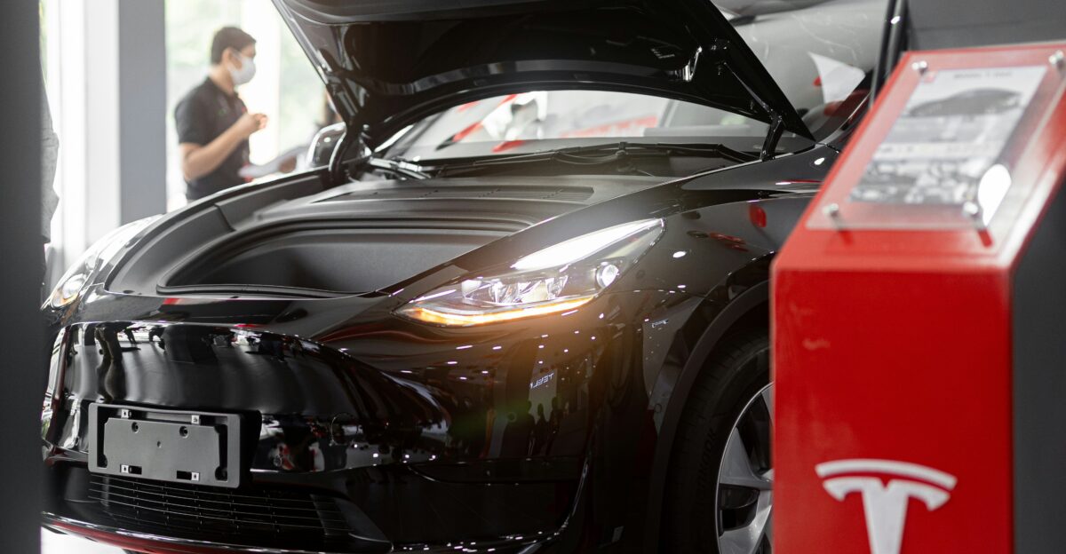a tesla car is on display in a showroom