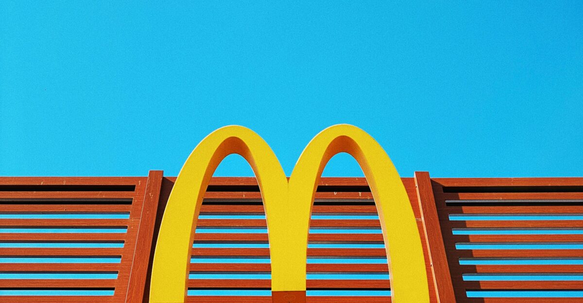 a wooden bench with a mcdonald s logo on it