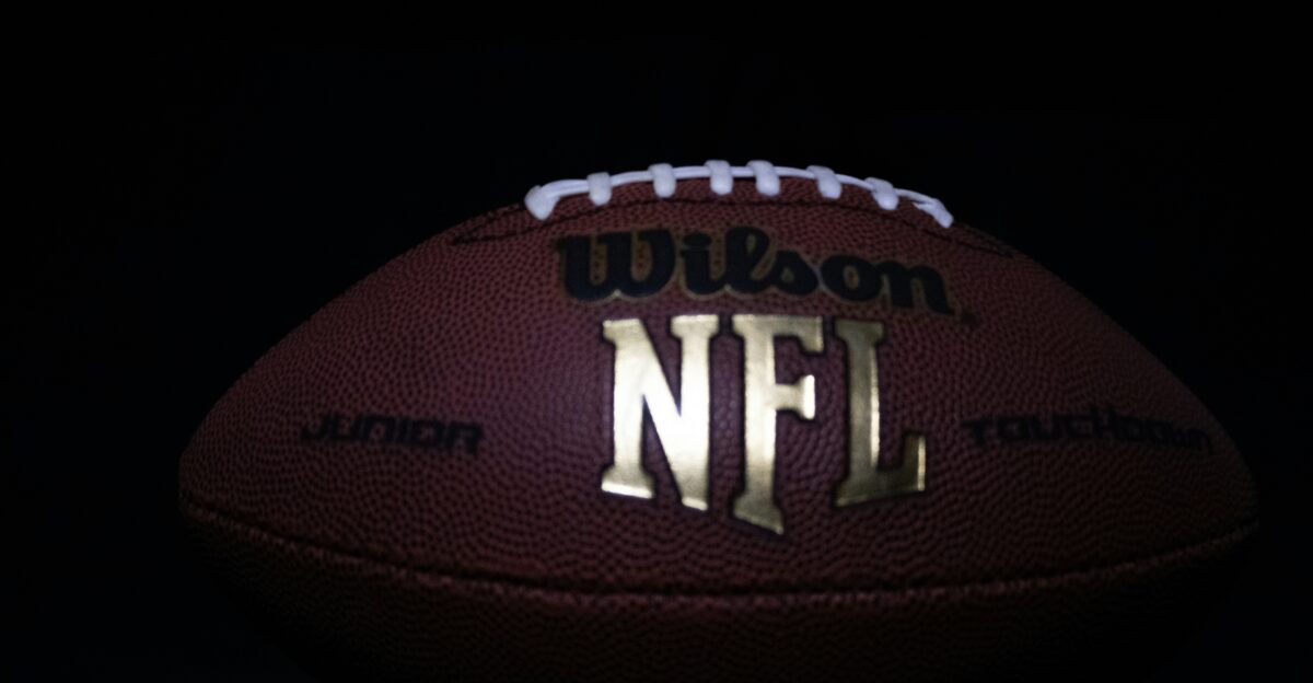 a close up of a football on a black background