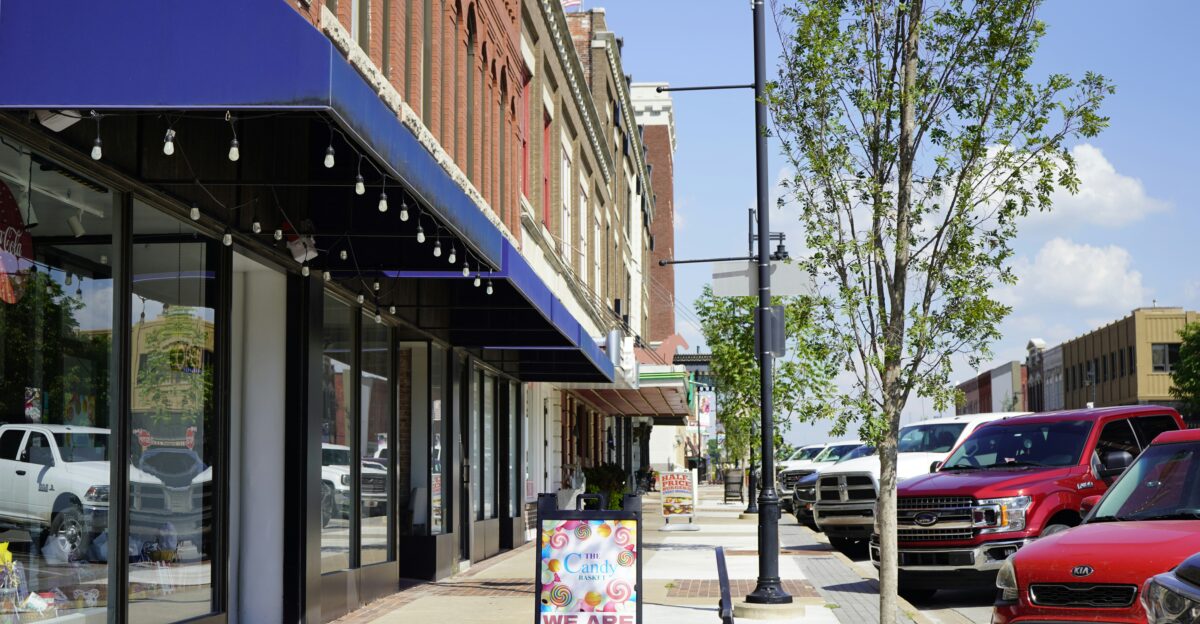 a sidewalk with cars parked on the side