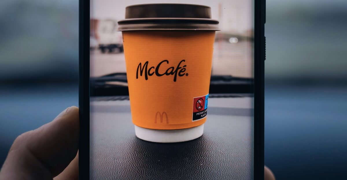 a hand holding a glass of beer