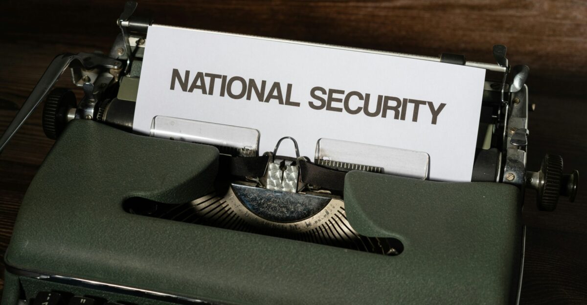 a close up of a typewriter with a national security sign on it
