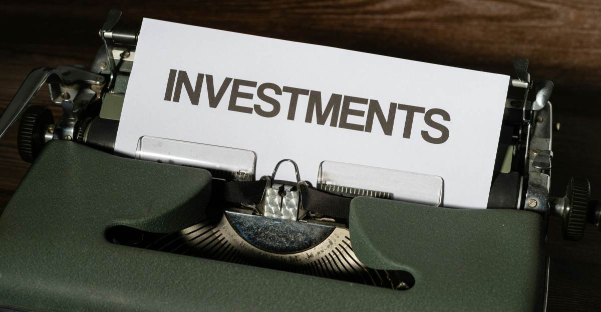 a close up of a typewriter with a paper that reads investments