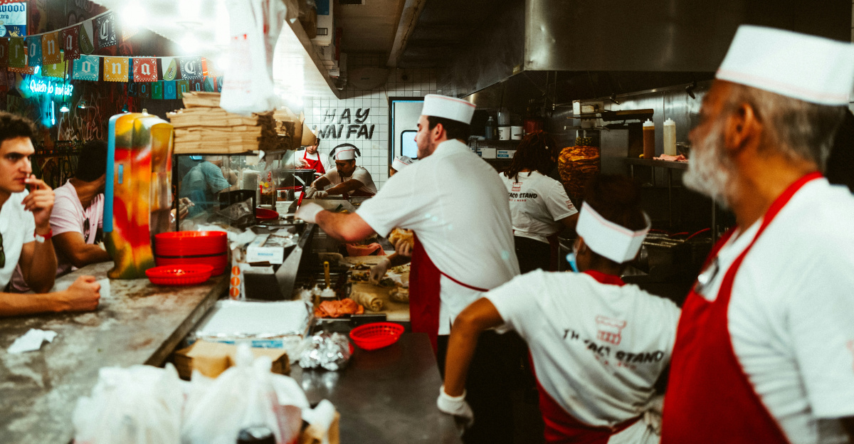 a group of people in a kitchen preparing food