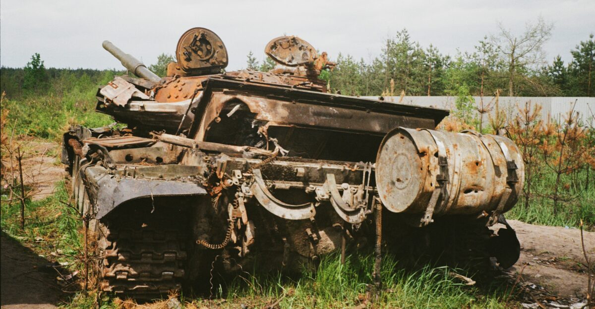 an old rusted out tank sitting in a field