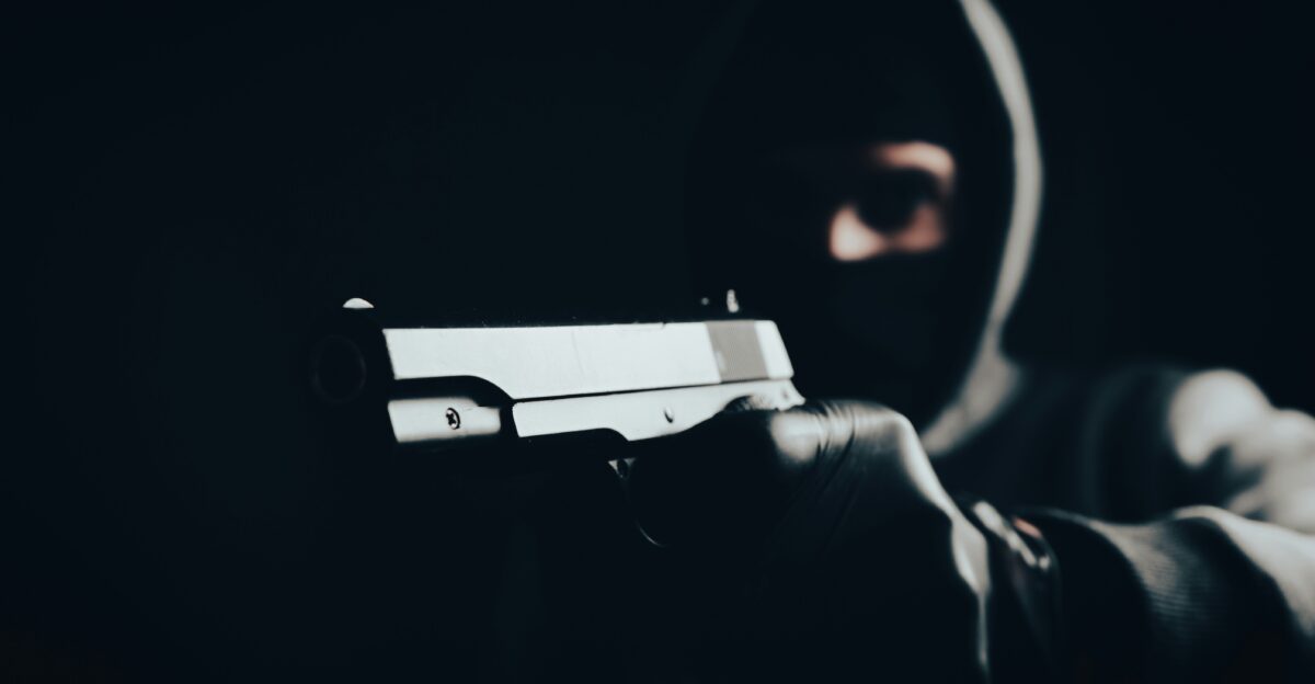 a man holding a gun in the dark