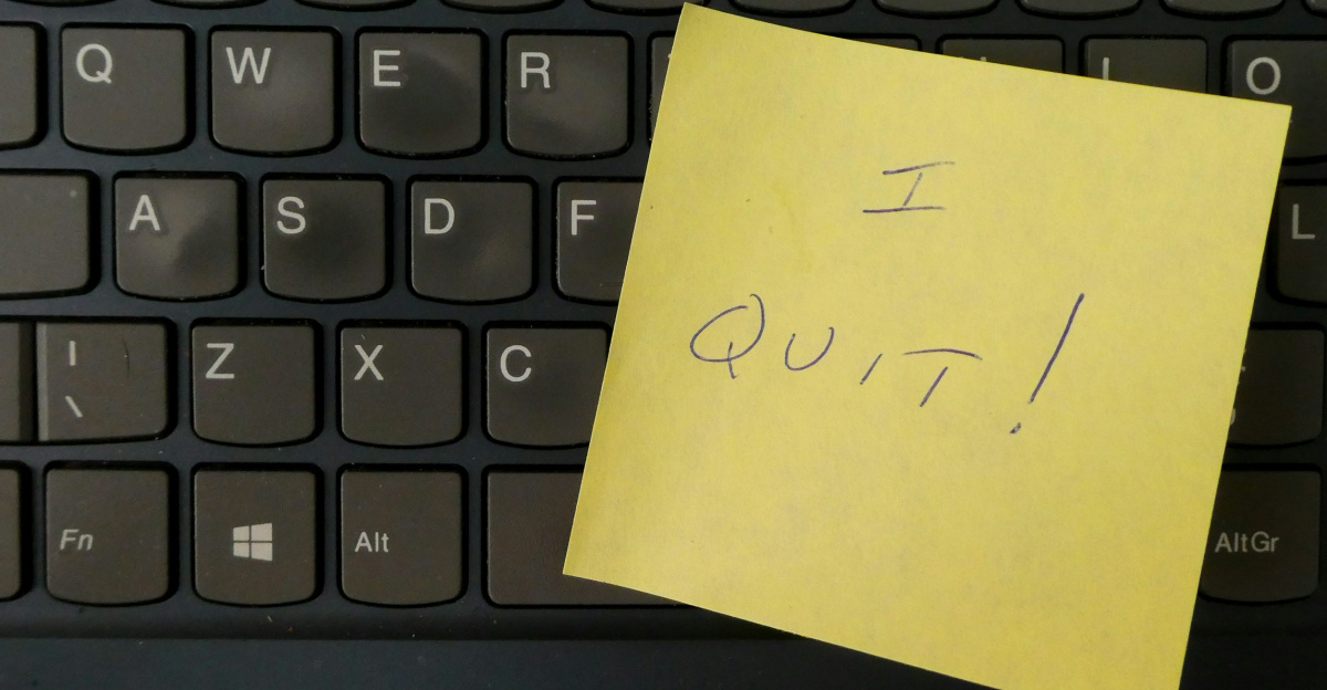 a yellow notepad on a keyboard