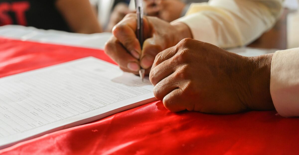 a person writing on a piece of paper