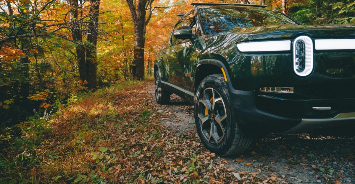a black car parked in a wooded area
