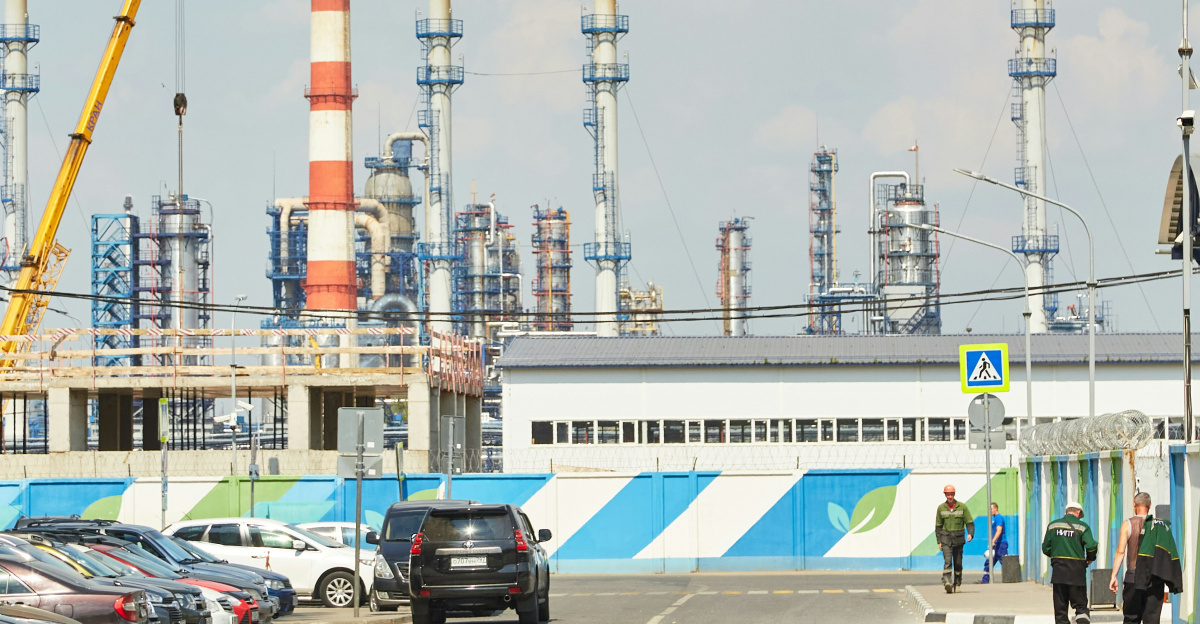 a road with cars and a building with a tower in the background