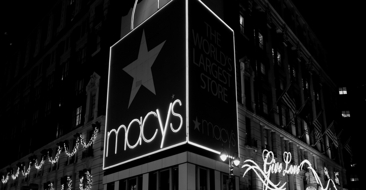a black and white photo of macy's at night