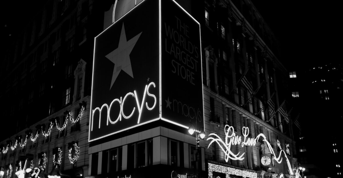 a black and white photo of macy s at night