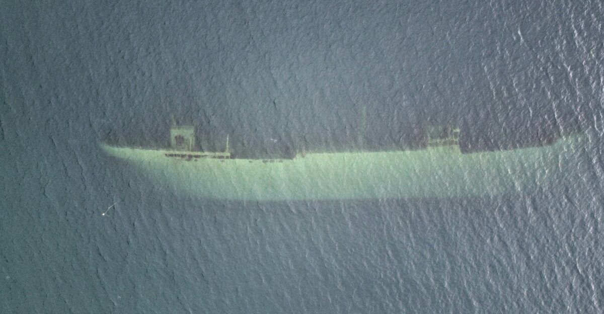an aerial view of a ship in the ocean