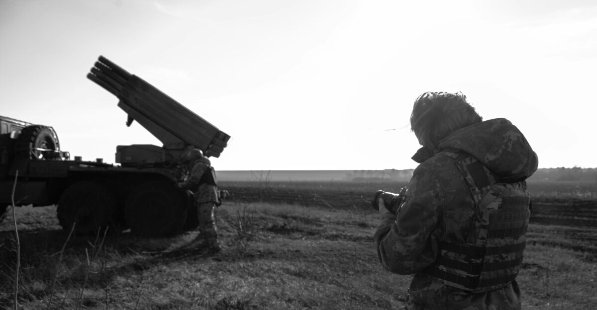 a man standing next to a truck in a field