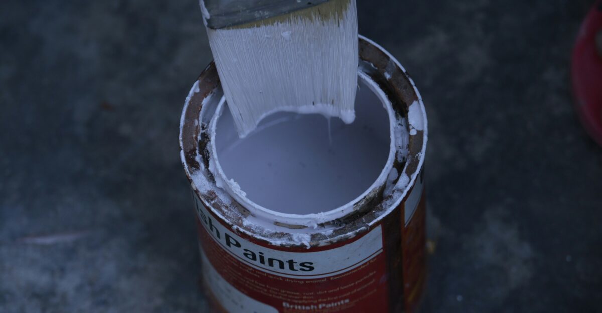 a paint can with a brush inside of it