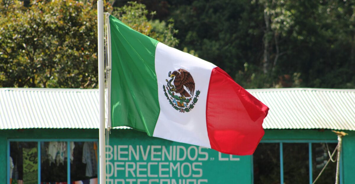 a mexican flag flying in front of a building